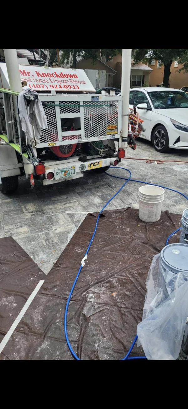 Professional spray rig and driveway protected with drop cloths