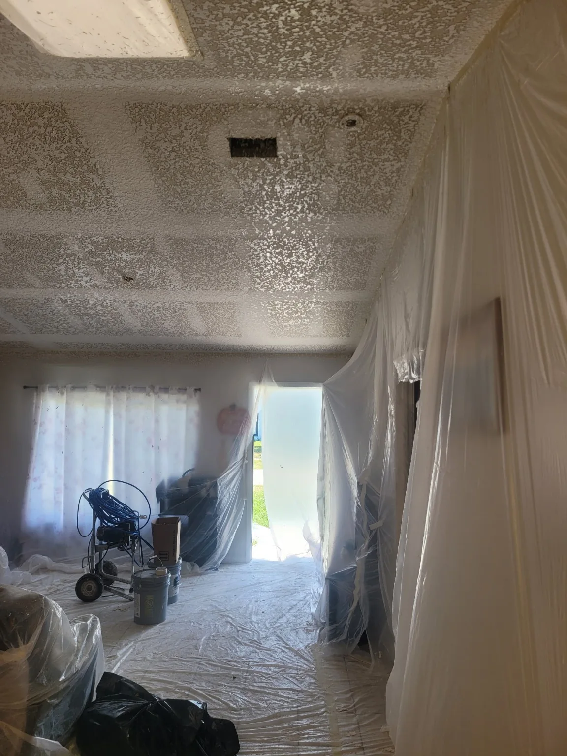 Interior masked and prepared for ceiling refinishing
